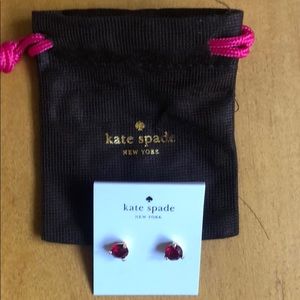 Red Kate Spade earrings.